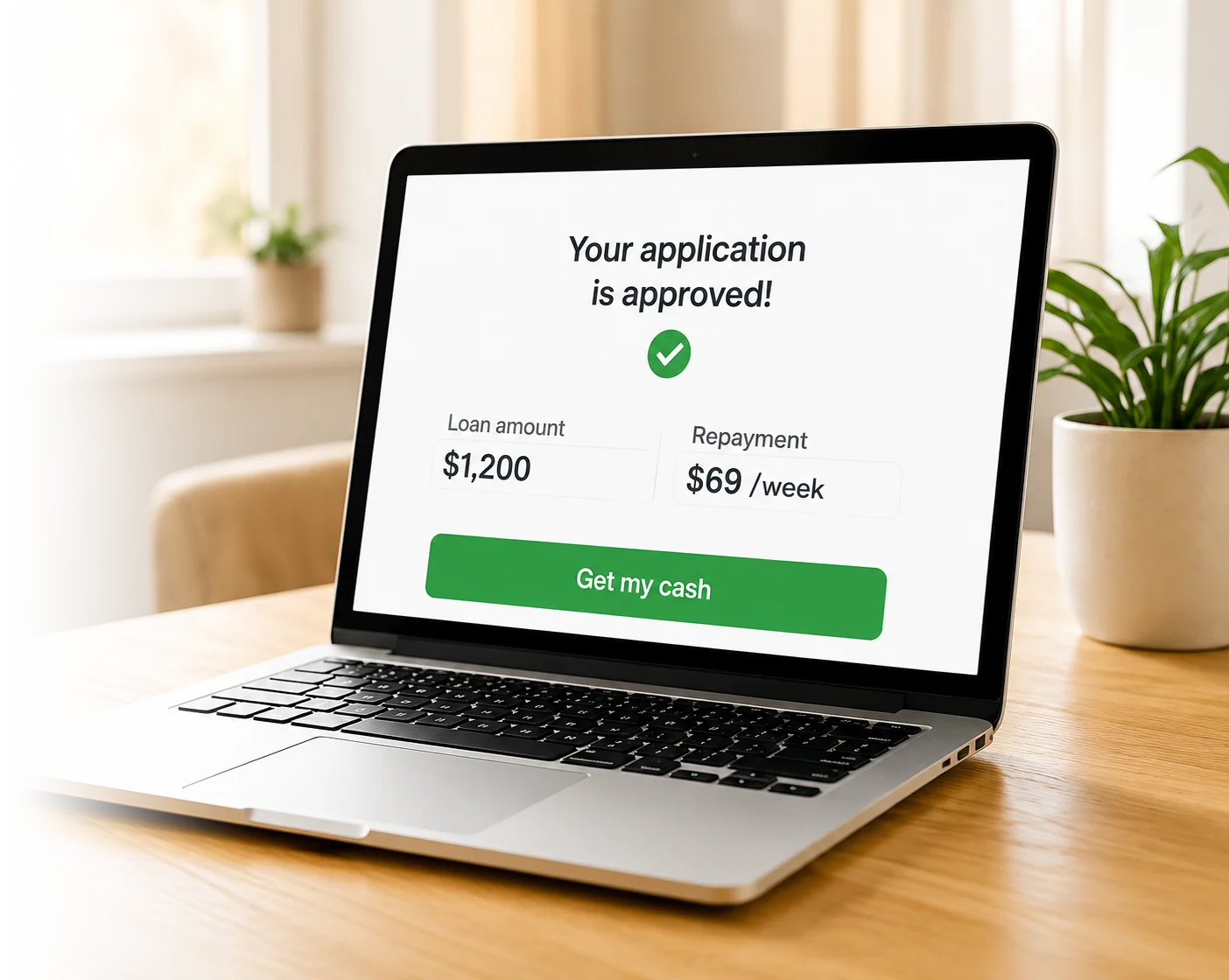 A laptop showing an approved loan application