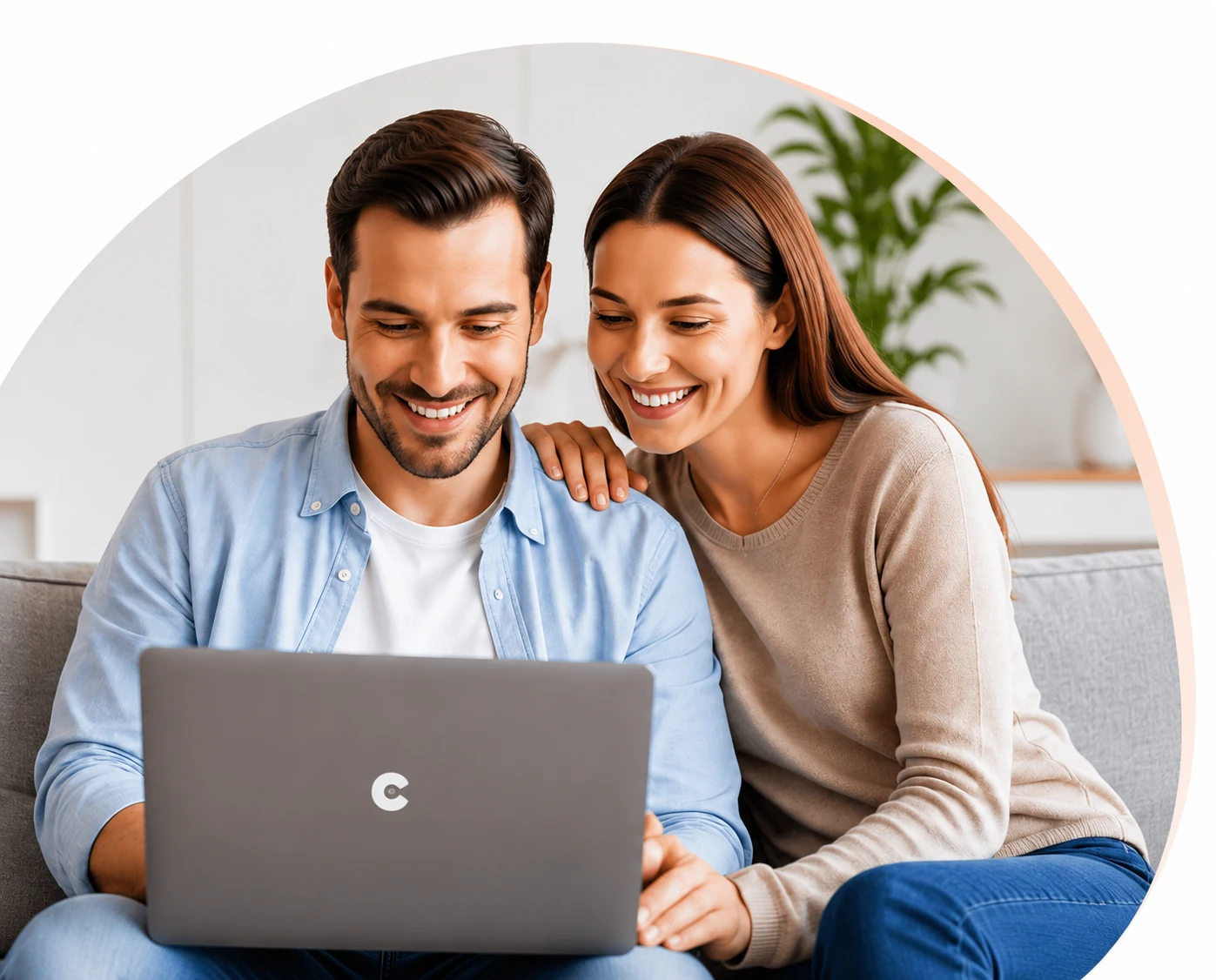 A couple smiling at a laptop together